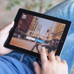 Man holding iPad with App LinkedIn on the screen