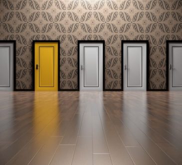 series of white doors with one yellow door in middle