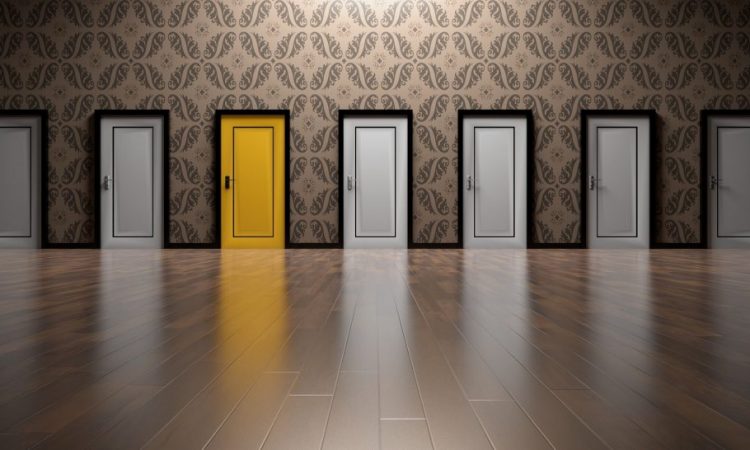 series of white doors with one yellow door in middle