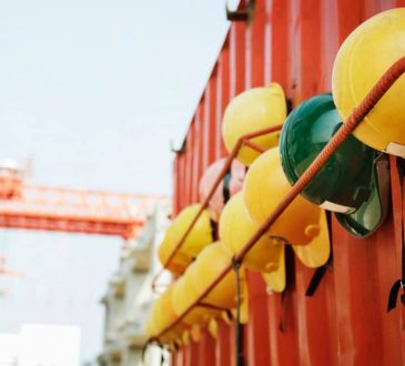 hard hats hanging on red trailer