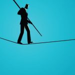 man walking on tightrope