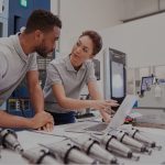 male and female engineers using computer