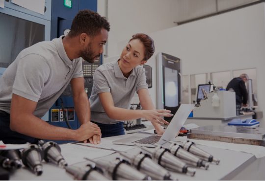 male and female engineers using computer