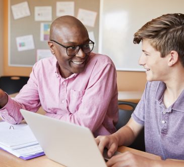 male teacher talking with male high school student