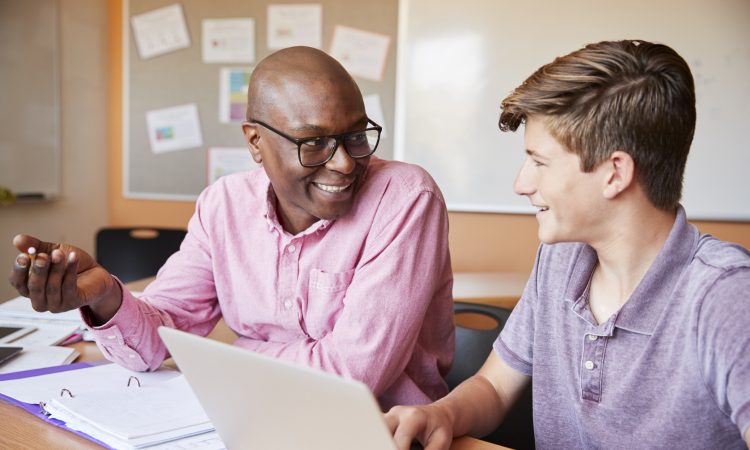 male teacher talking with male high school student
