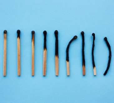 Burned matches in a row on a blue background.