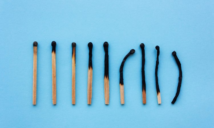 Burned matches in a row on a blue background.