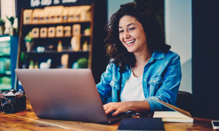 Woman watching video on laptop in cafe
