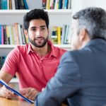 two men talking in office
