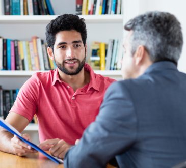 two men talking in office