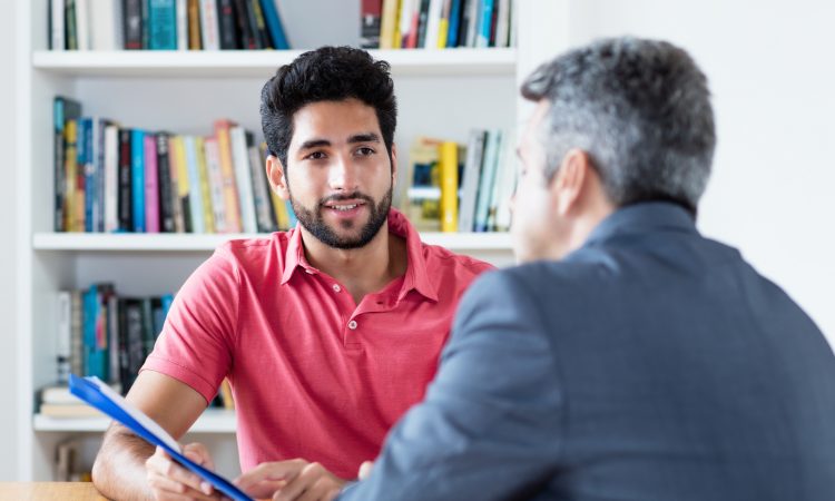 two men talking in office