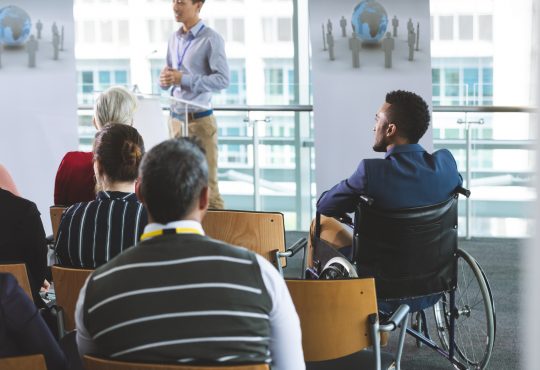 people attending seminar in office