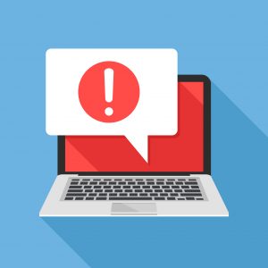 Laptop and speech bubble with exclamation mark icon on screen.