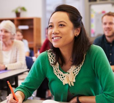 woman looking at the board in an adult education class