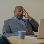 stressed man sitting at desk