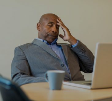 stressed man sitting at desk