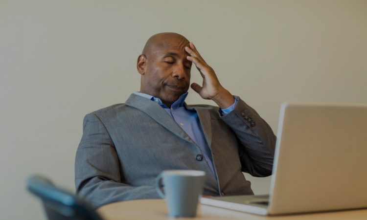 stressed man sitting at desk