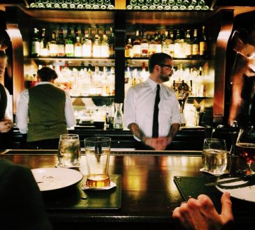 bartender standing behind bar
