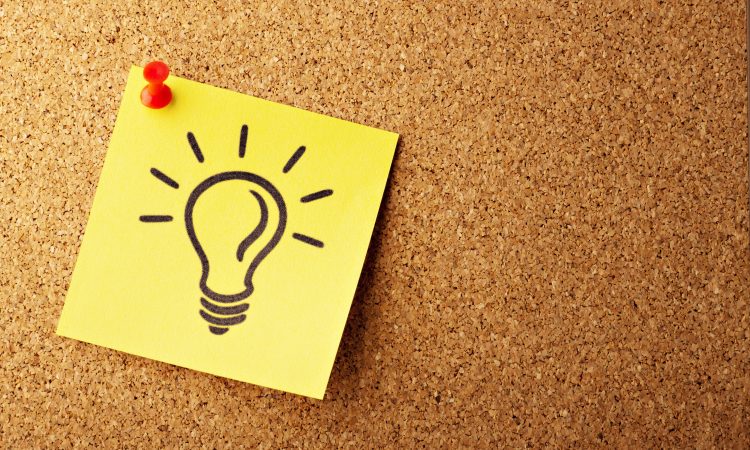 light bulb drawn on post-it pinned to bulletin board
