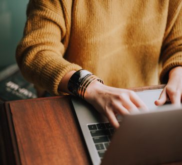 person typing on laptop
