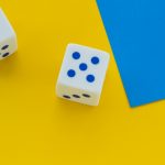 dice on bright yellow background