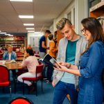 teacher with student in library