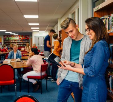 teacher with student in library