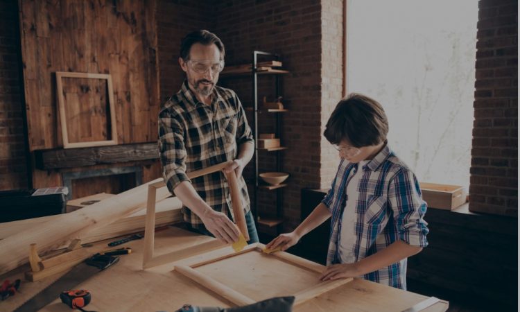 dad and son doing woodworking