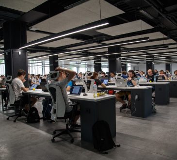 people working at desks in open concept office