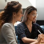 two women working together in office