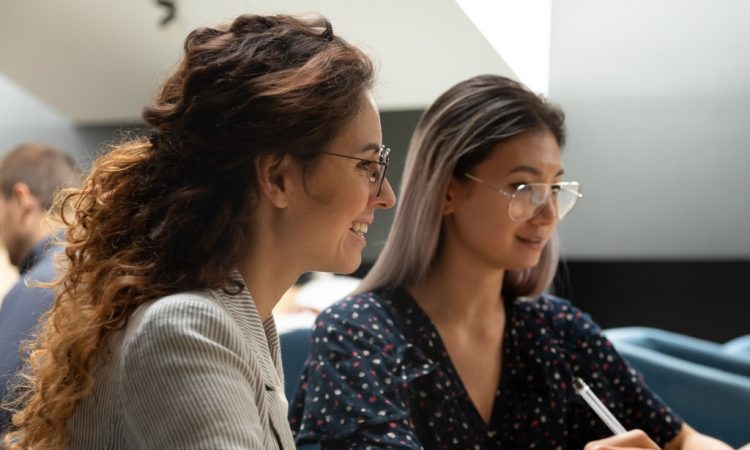 two women working together in office