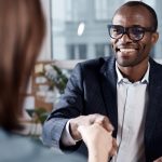 man shakes hands with person at work
