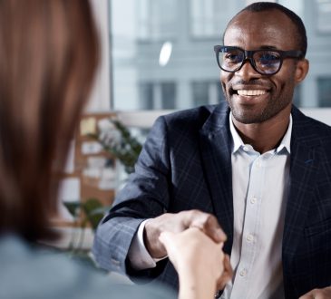 man shakes hands with person at work