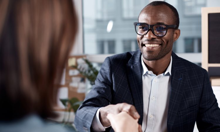 man shakes hands with person at work
