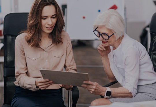 older woman and younger woman discussing something at work