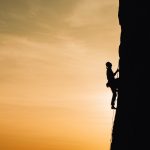 person climbing mountain