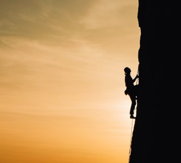 person climbing mountain
