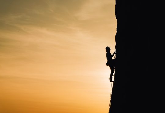 person climbing mountain
