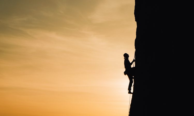 person climbing mountain