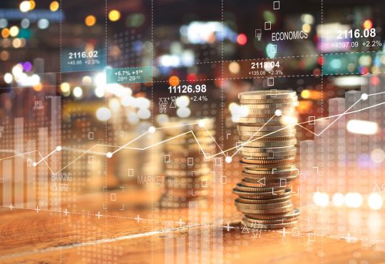 usinesss charts of graph and rows of coins for finance at night city background.