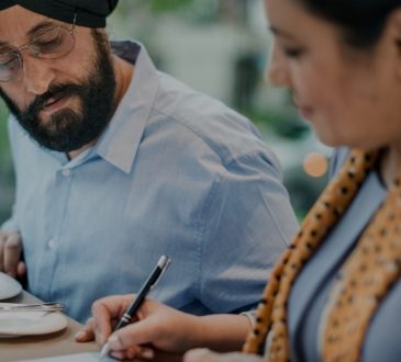man and woman filling out form together