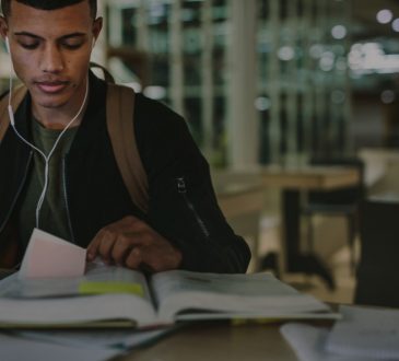 student looking at book