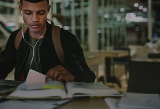 student looking at book