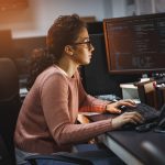 Female programmer working on new project.