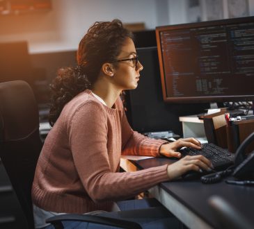 Female programmer working on new project.