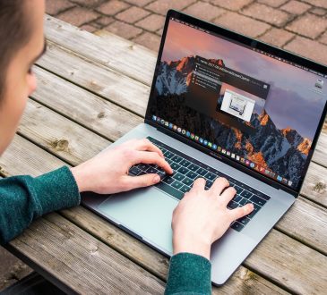 man typing on laptop