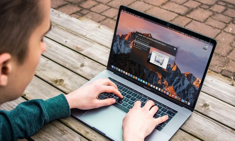 man typing on laptop