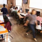 Elevated View Of Workers In Busy Modern Design Office