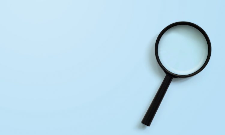 Magnifying glass on blue colour background