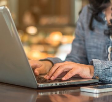 woman typing on laptop